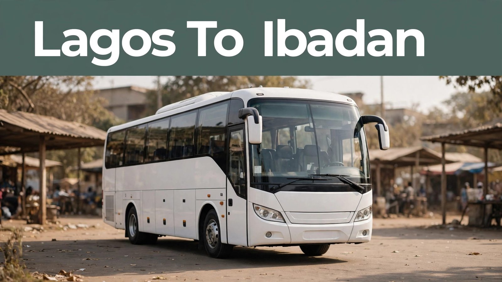 White coach bus parked at a sunny Nigerian motor park terminal.