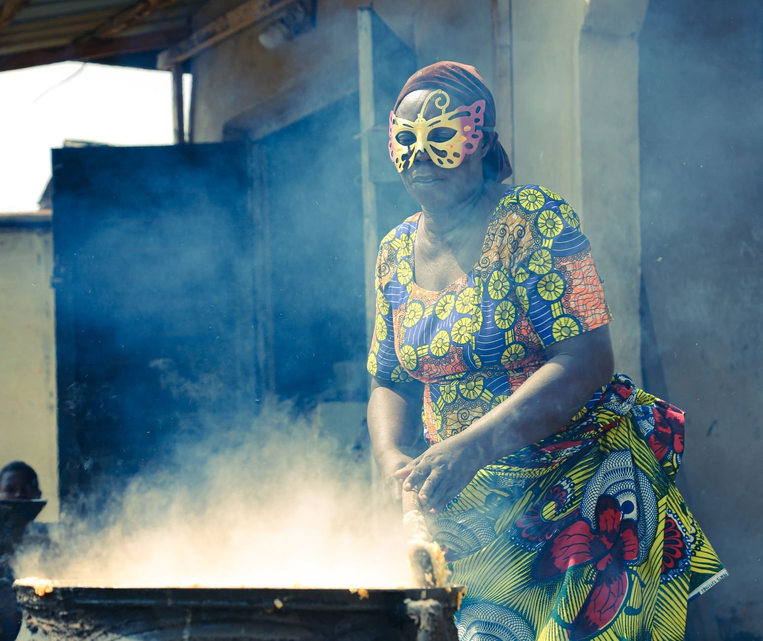 Street food being cooked over smoke in a Lagos market