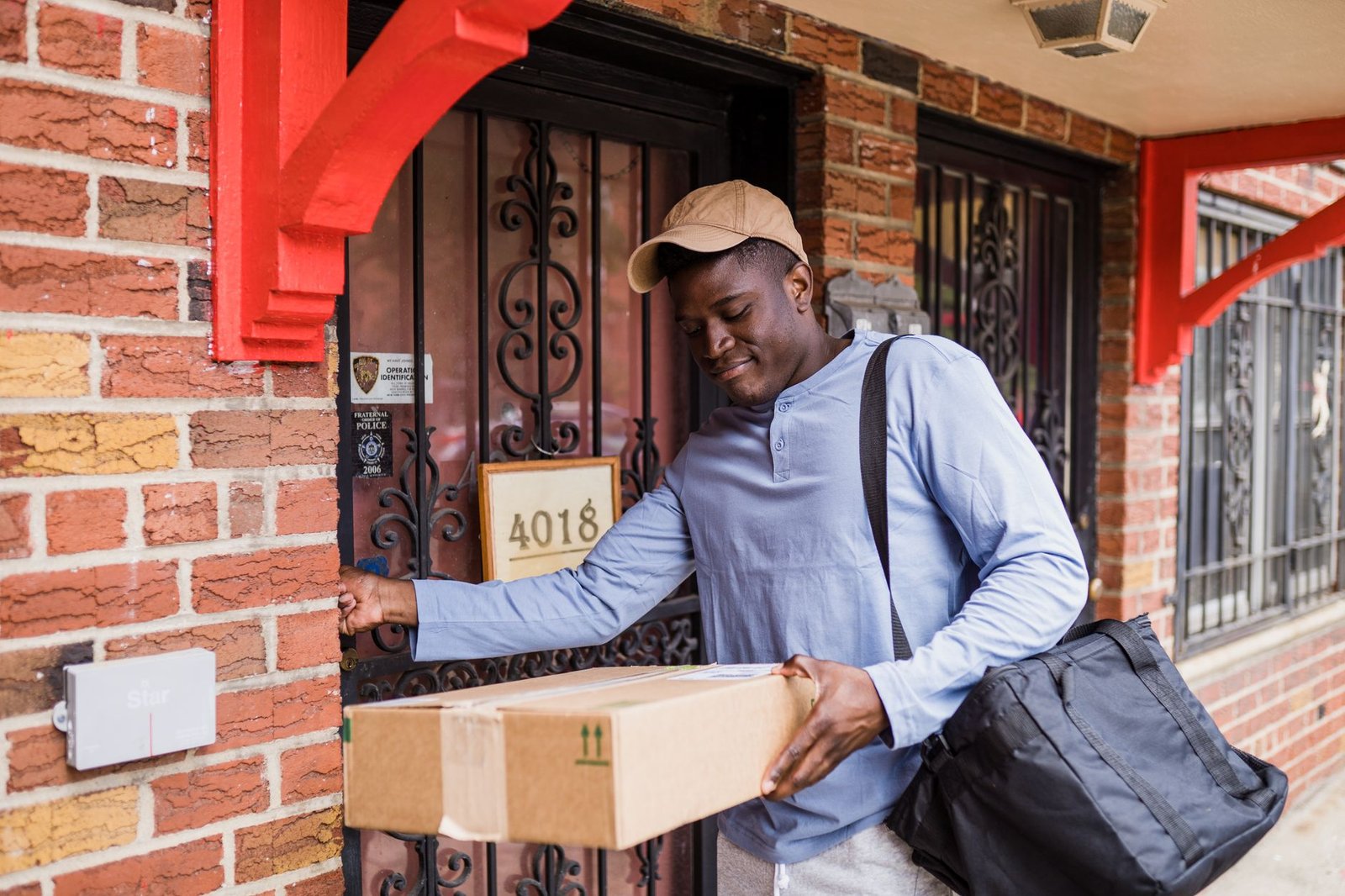 A courier delivers a package to a residential front door