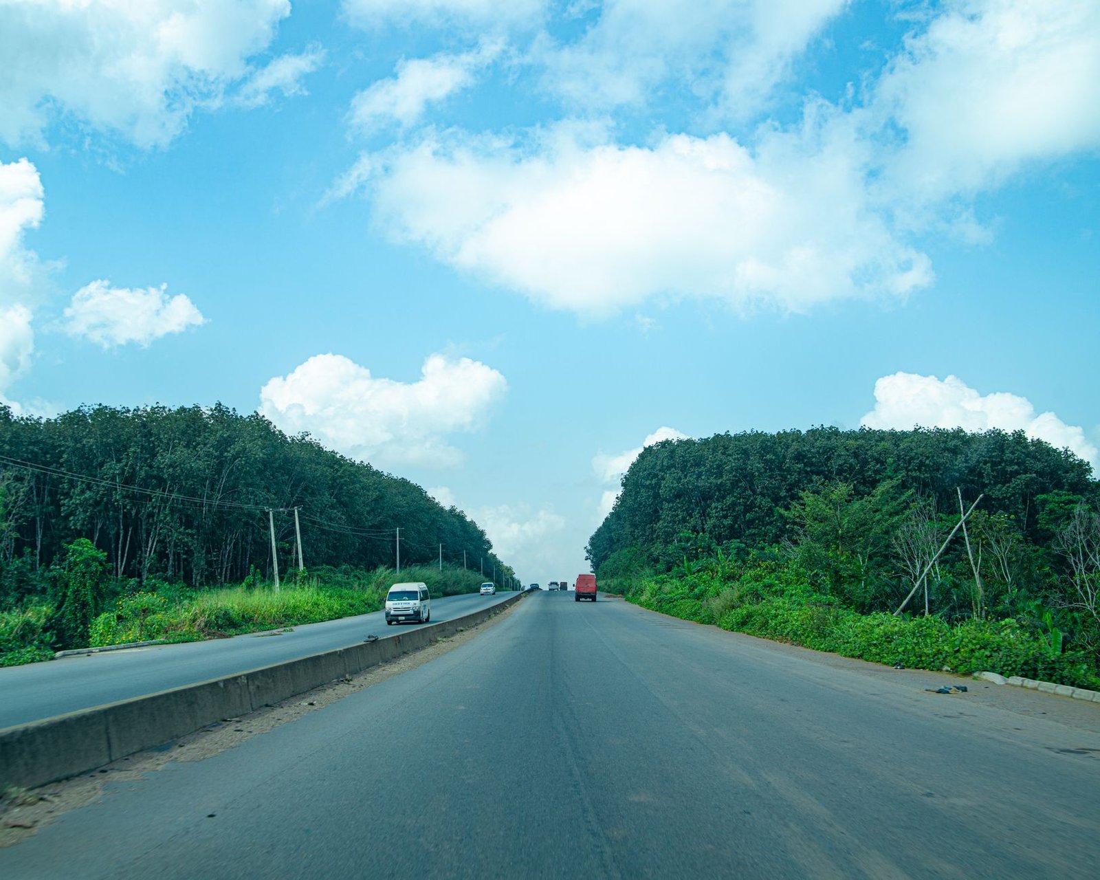 Highway cutting through green forest near Lagos
