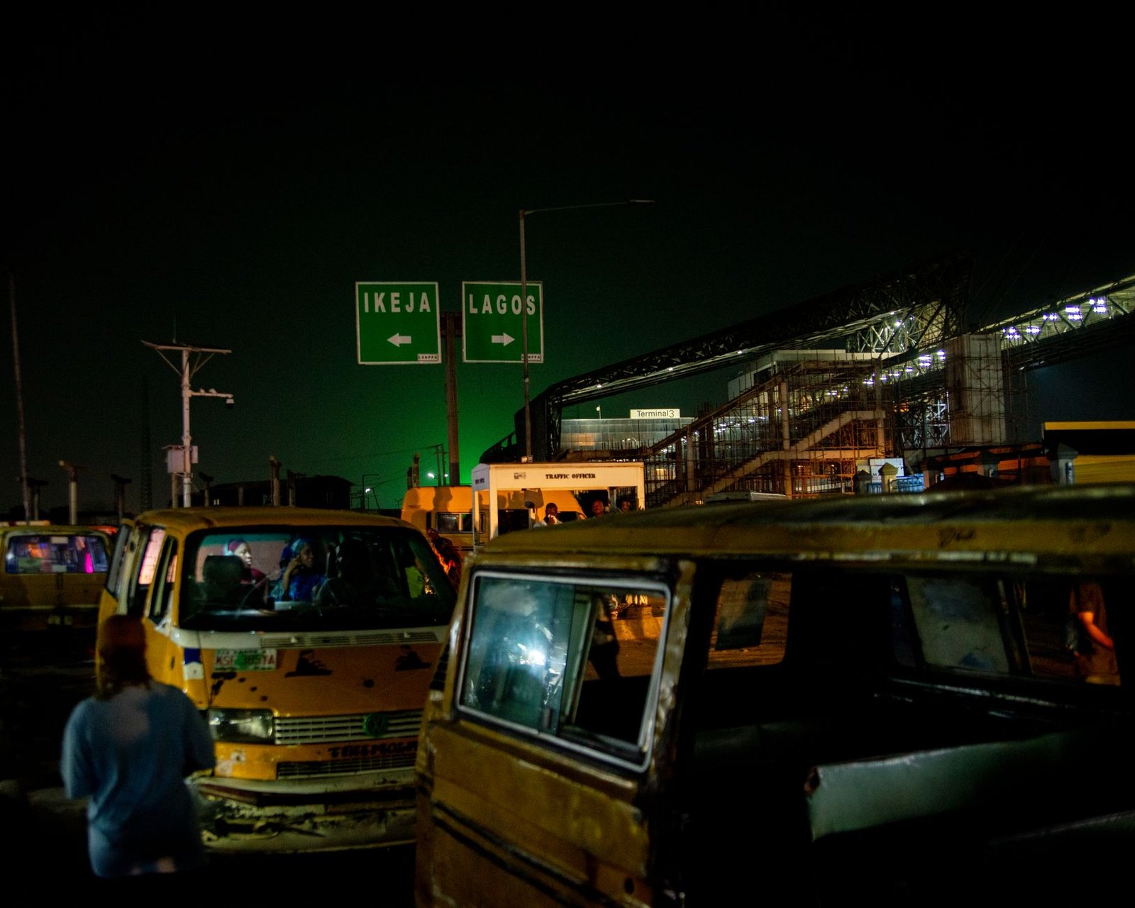 Bustling nightlife in Lagos with vibrant city lights and traffic at a busy road intersection.