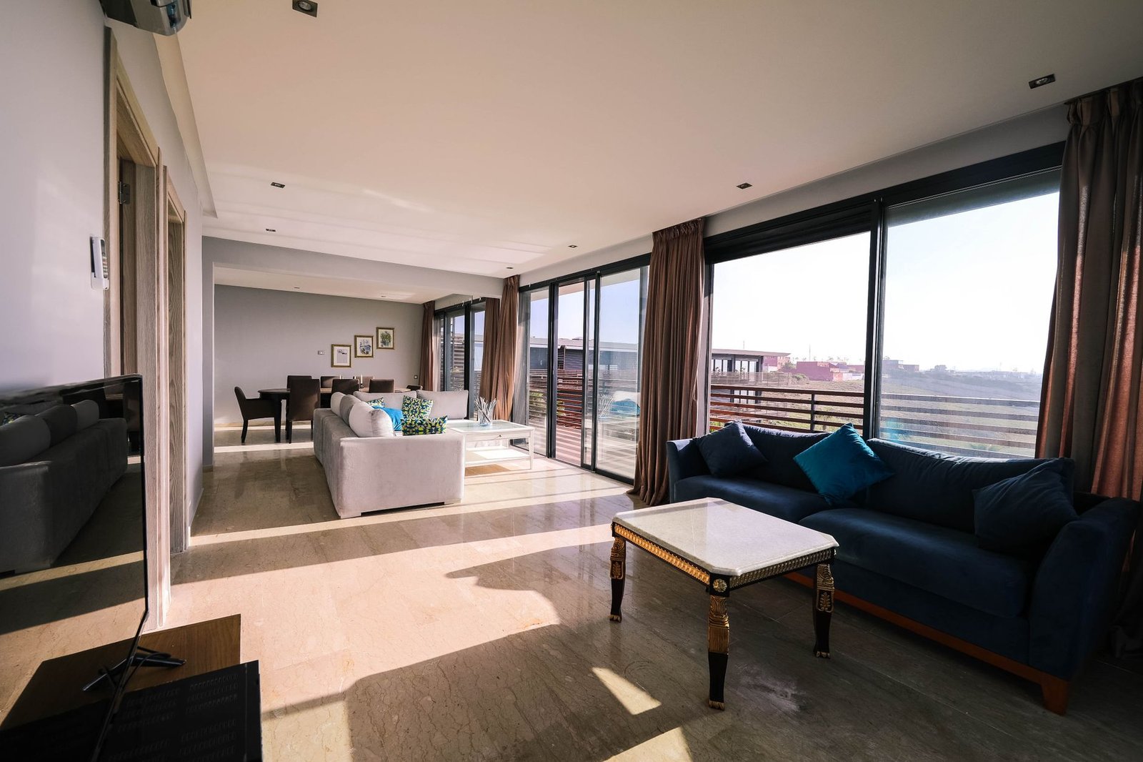 Bright and airy contemporary living room with furniture and large windows overlooking a city view