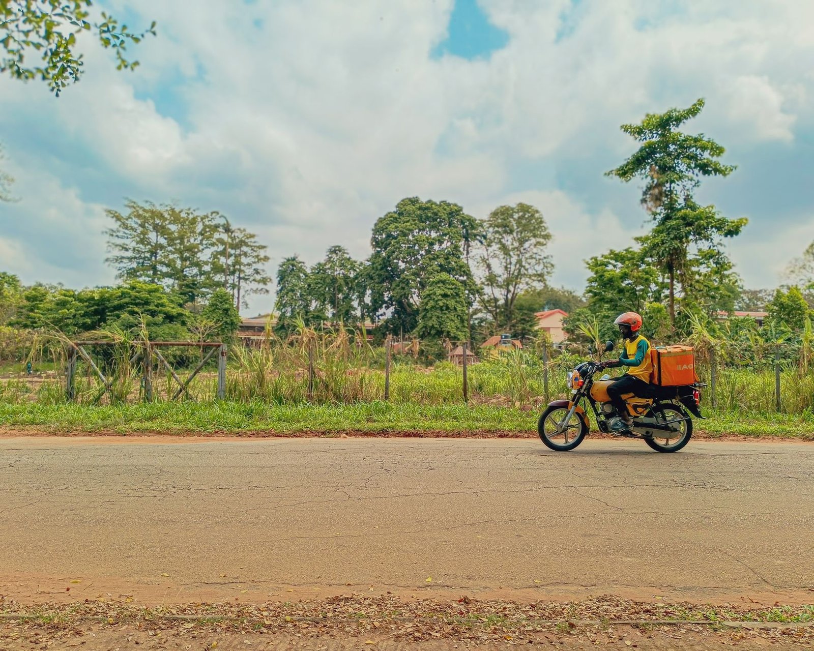 Motorbike courier riding along a Lagos road