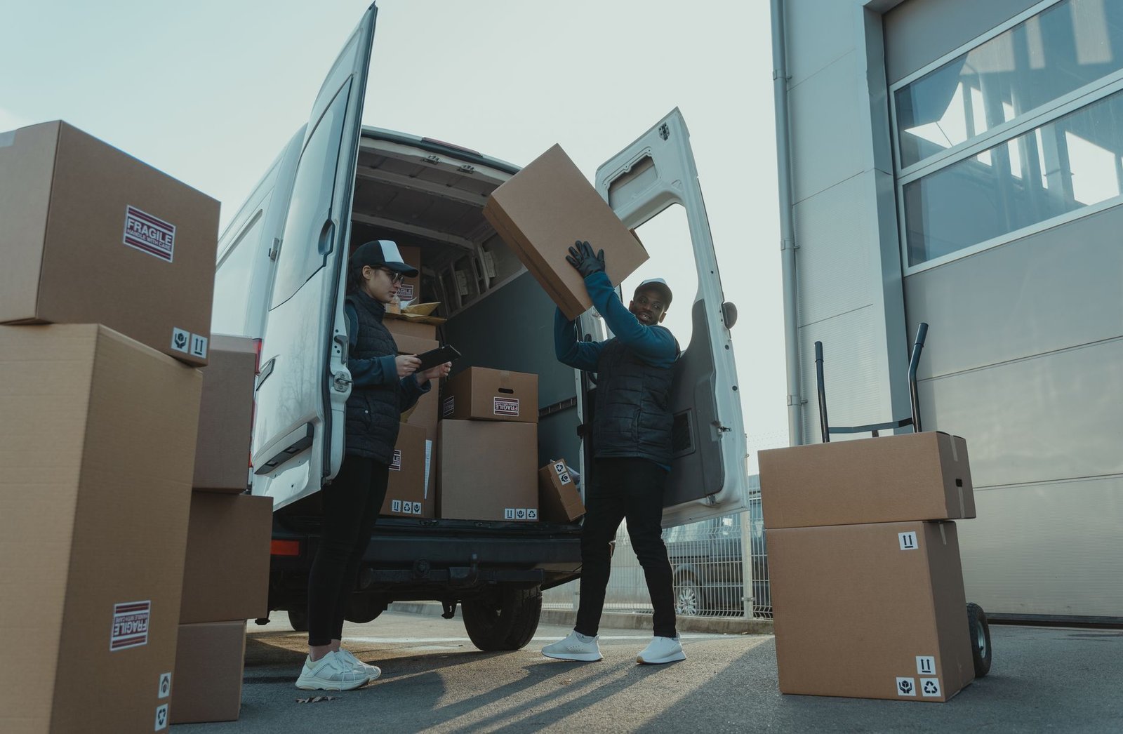Workers loading boxes into a delivery van
