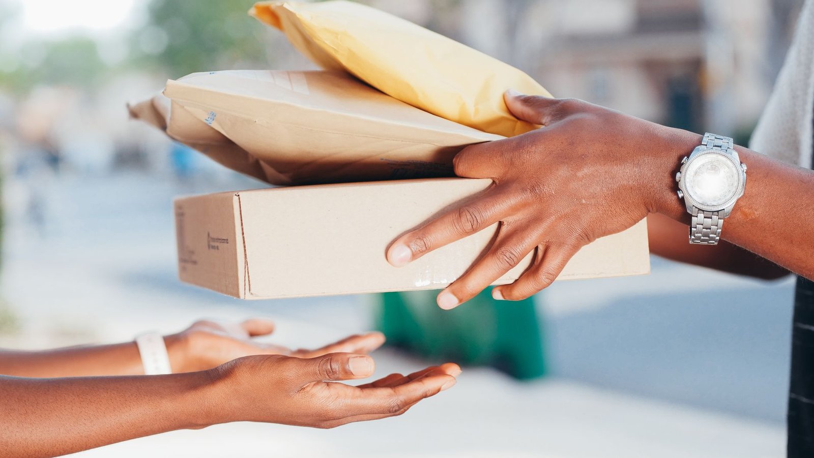 Delivery rider handing a package to a recipient